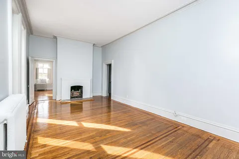 a view of living room with furniture and a fireplace