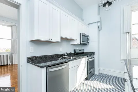 a kitchen with stainless steel appliances granite countertop a stove a microwave and oven