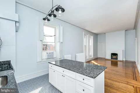 a view of a bedroom with a bed and a window
