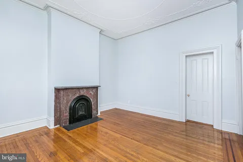 a view of walk in closet with wooden floor