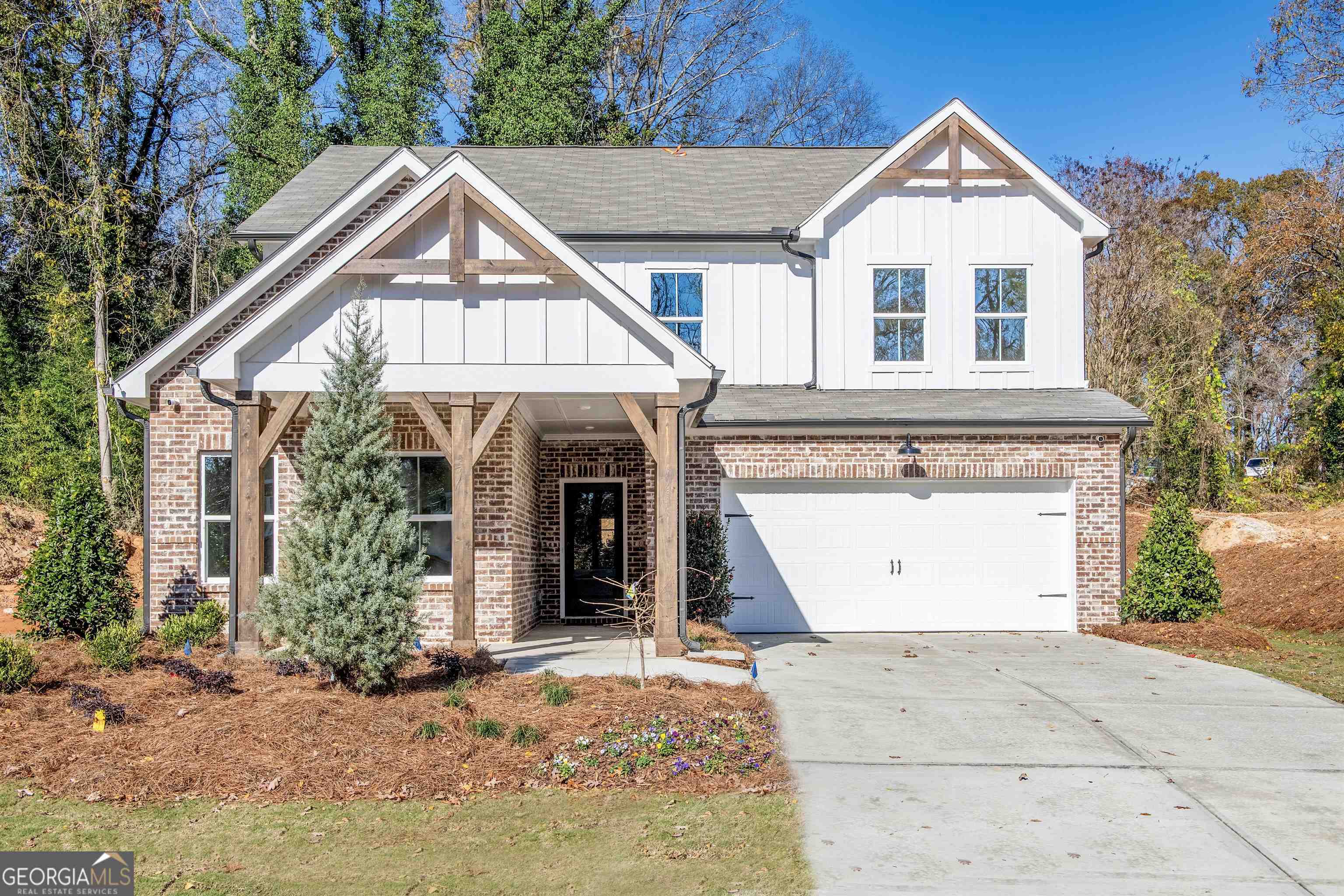 Beautiful Farmhouse style exterior on wooded lots