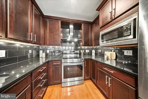 a kitchen with stainless steel appliances granite countertop a sink and stove