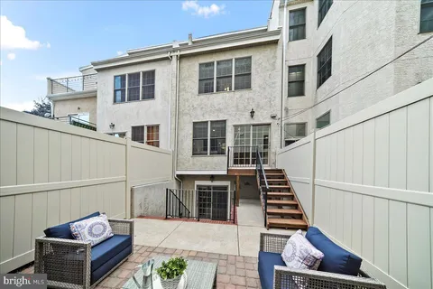 a living room with furniture and a flat screen tv with wooden floor