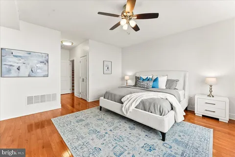 a spacious bedroom with a bed a couch and a window