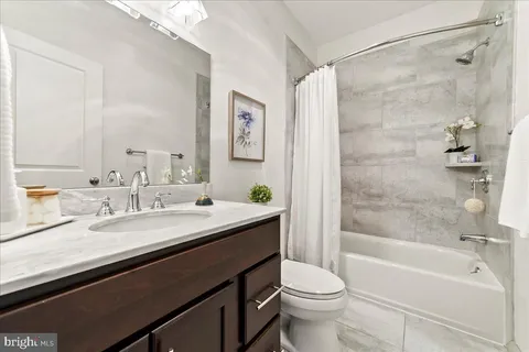 a spacious bedroom with a bed a table and a couch