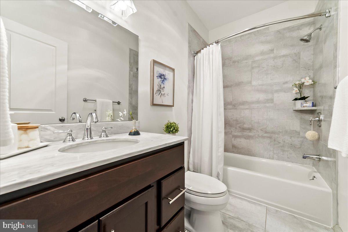 677 North 15th Street Philadelphia, PA 19130 - Photo 39 of 52 a bathroom with a granite countertop sink toilet and shower