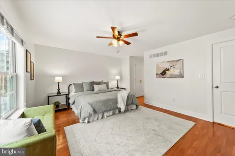 a bathroom with a granite countertop sink a toilet and a mirror