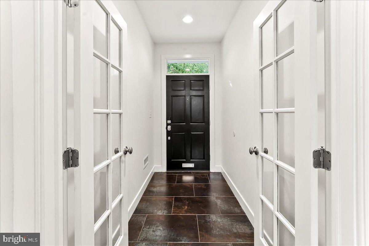 677 North 15th Street Philadelphia, PA 19130 - Photo 6 of 52 a view of a hallway with wooden floor and staircase