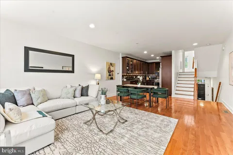 a living room with furniture kitchen view and a table