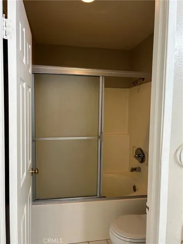 a bathroom with a shower and a toilet