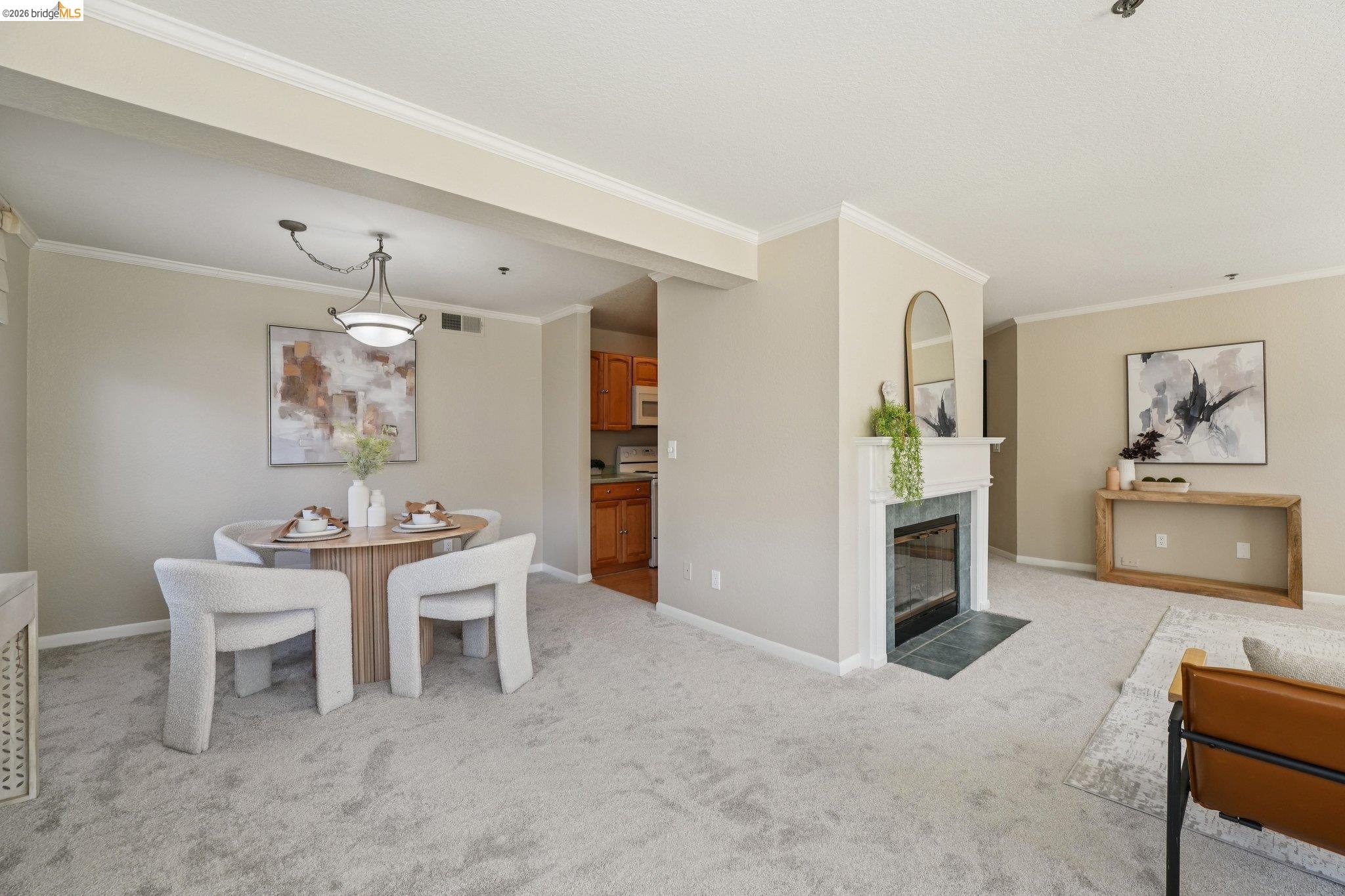 535 Pierce Street, Unit 3216 Albany, CA 94706 - Photo 11 of 47 Dining space with ornamental molding, light colored carpet, and a tiled fireplace