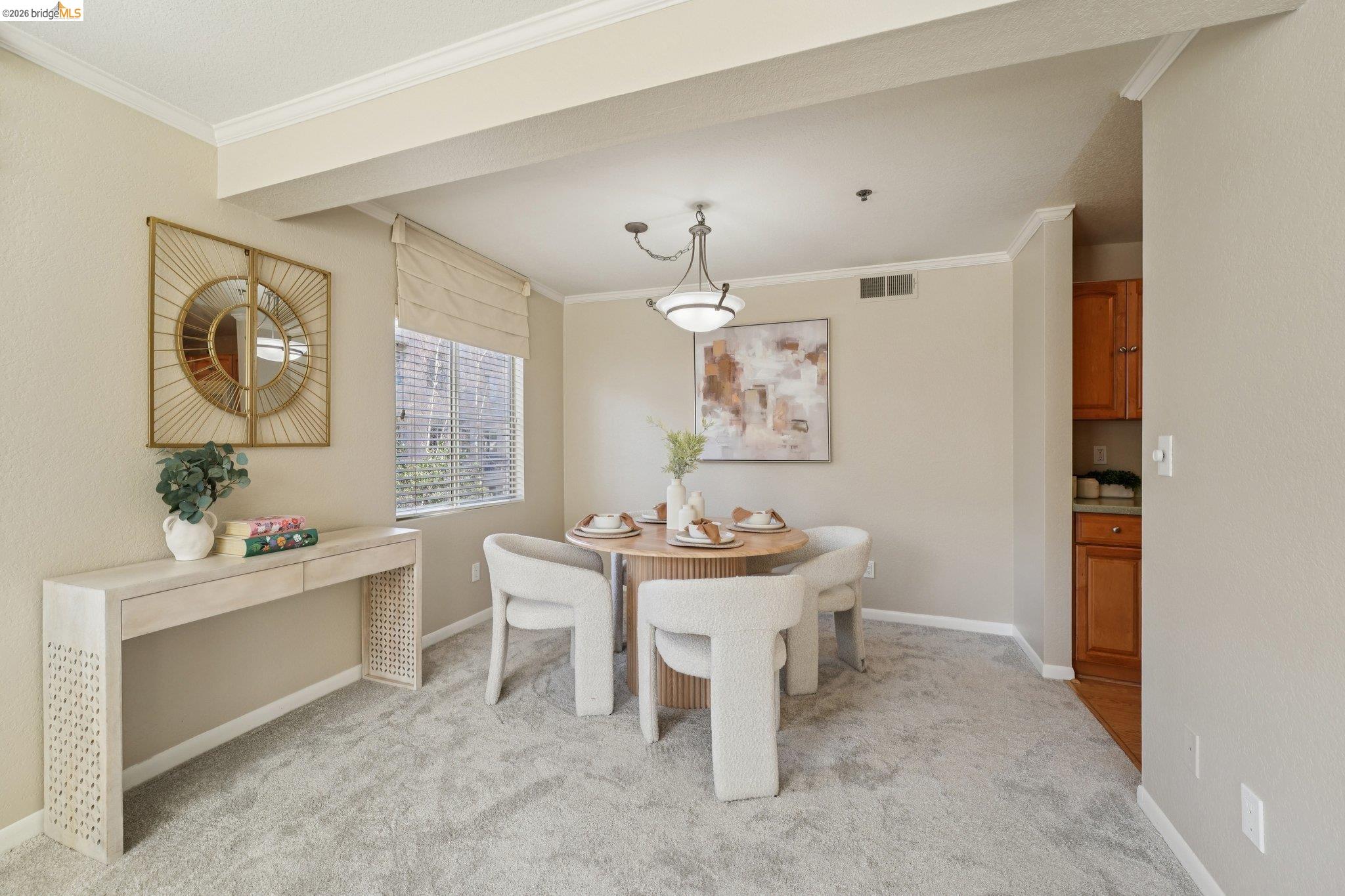 535 Pierce Street, Unit 3216 Albany, CA 94706 - Photo 16 of 47 Dining room with crown molding and light carpet
