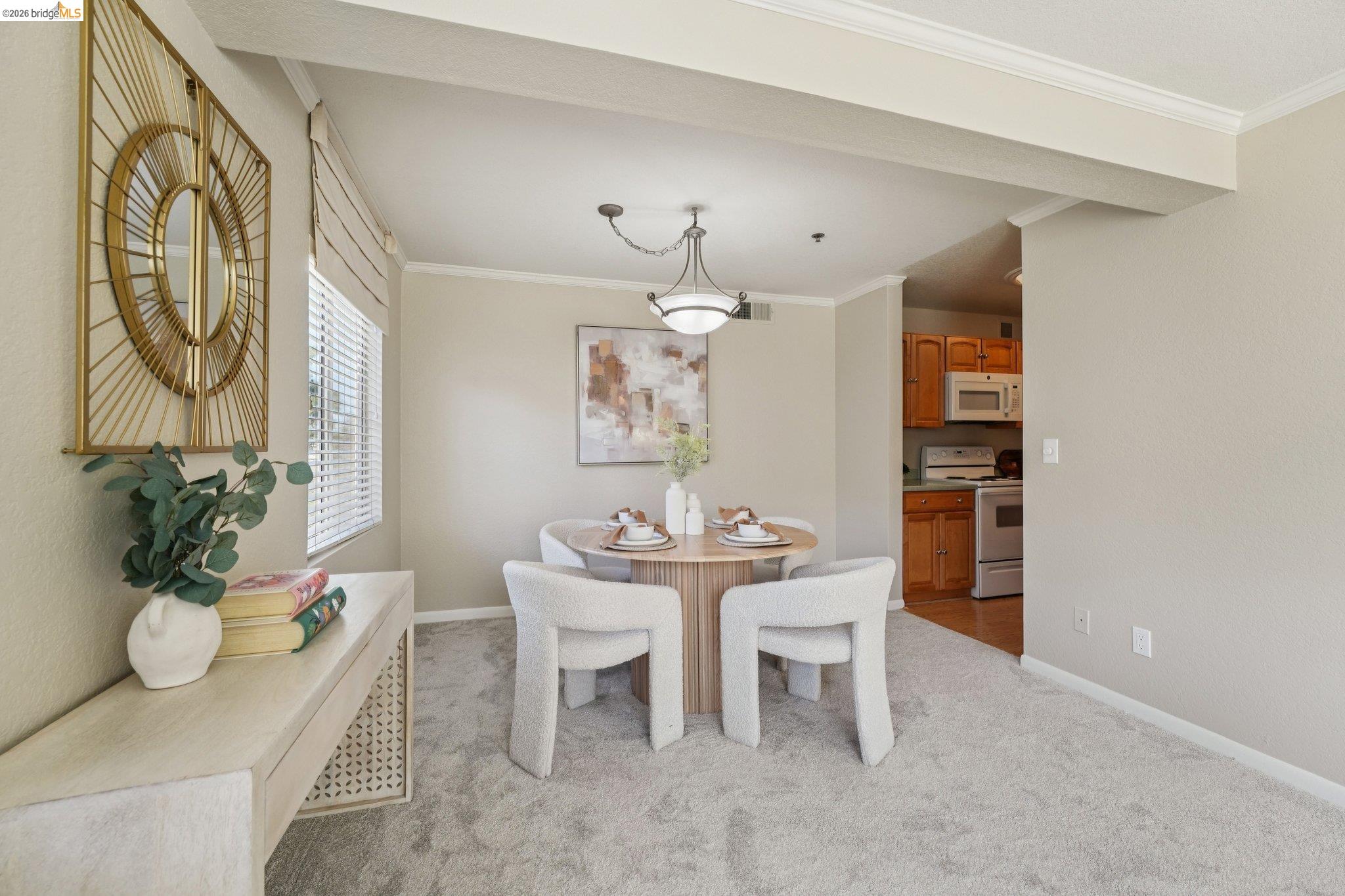 535 Pierce Street, Unit 3216 Albany, CA 94706 - Photo 17 of 47 Dining space with crown molding and light colored carpet