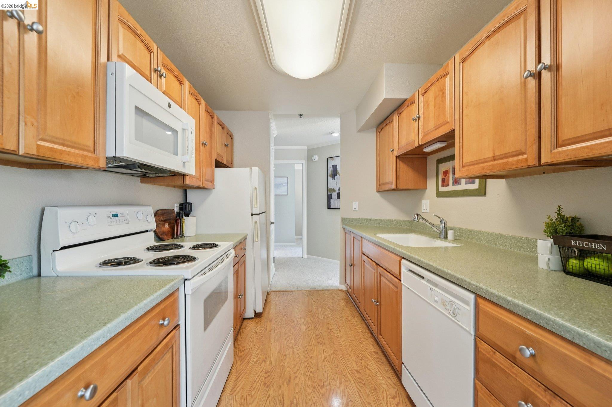 535 Pierce Street, Unit 3216 Albany, CA 94706 - Photo 18 of 47 Kitchen featuring white appliances, light wood-type flooring, and light countertops