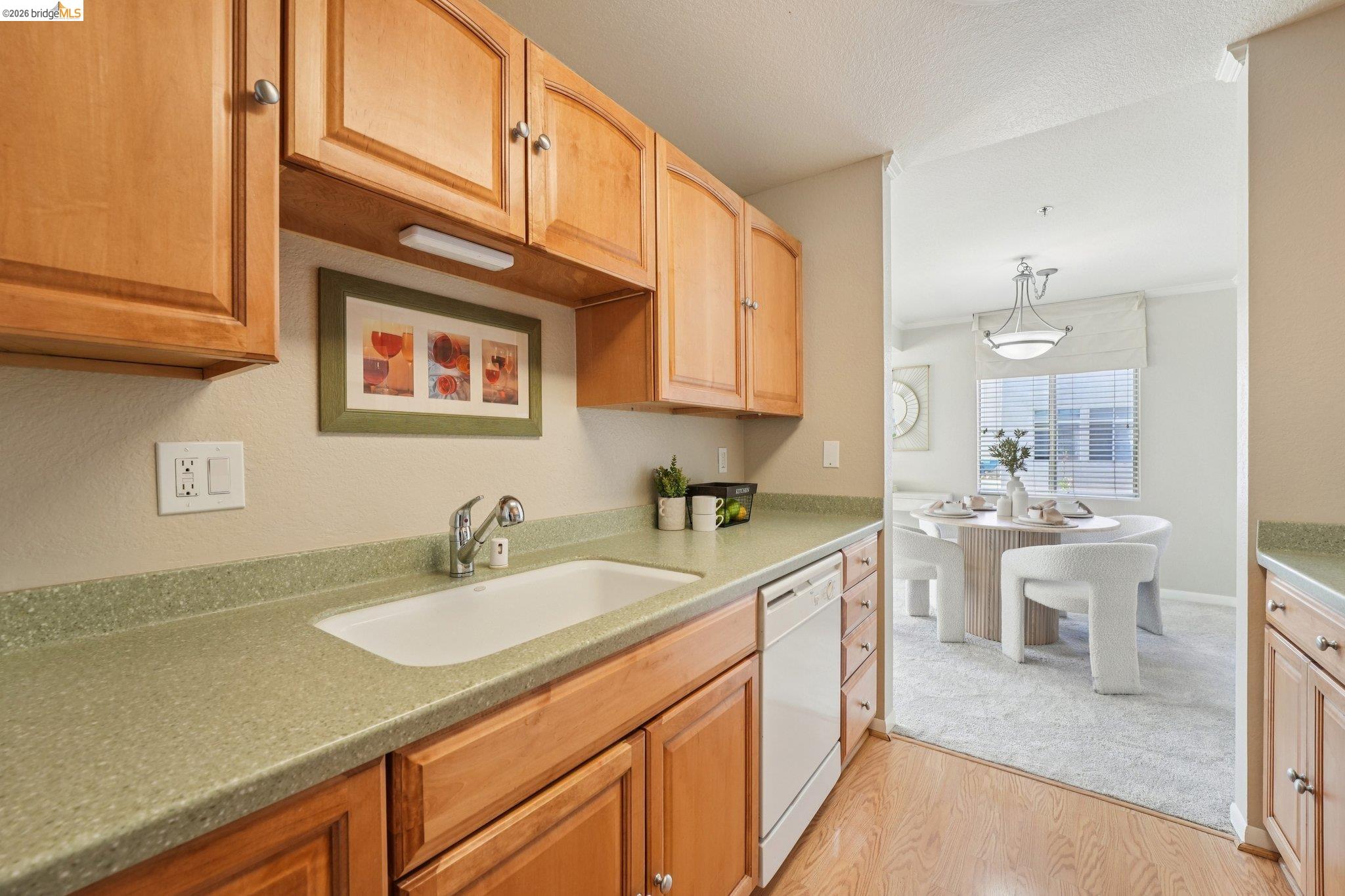 535 Pierce Street, Unit 3216 Albany, CA 94706 - Photo 22 of 47 Kitchen featuring light wood finished floors, white dishwasher, pendant lighting, and a textured ceiling