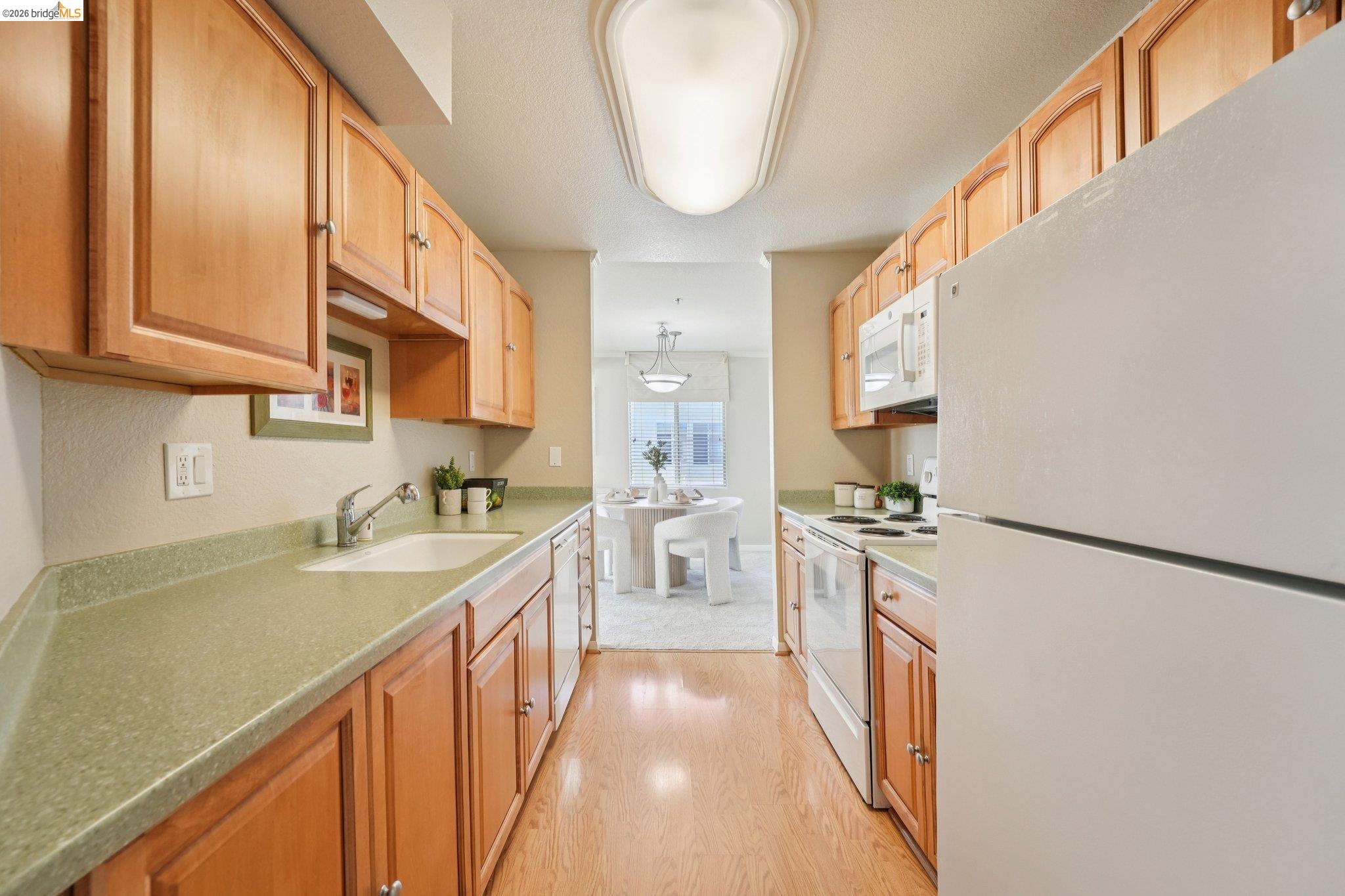 535 Pierce Street, Unit 3216 Albany, CA 94706 - Photo 24 of 47 Kitchen with white appliances, light wood-style flooring, and light countertops