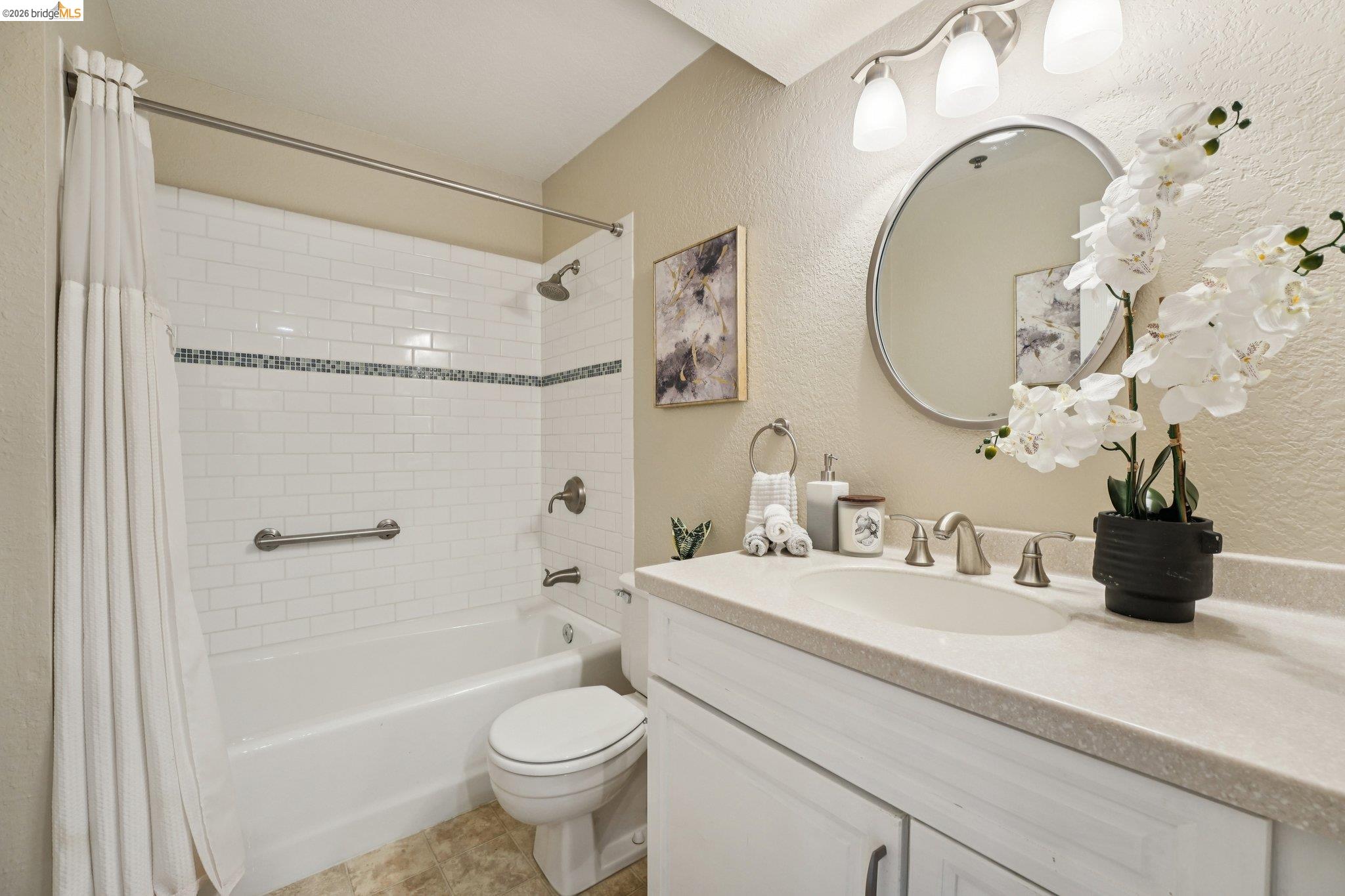 535 Pierce Street, Unit 3216 Albany, CA 94706 - Photo 25 of 47 Full bathroom featuring a textured wall, vanity, and shower / bathtub combination with curtain