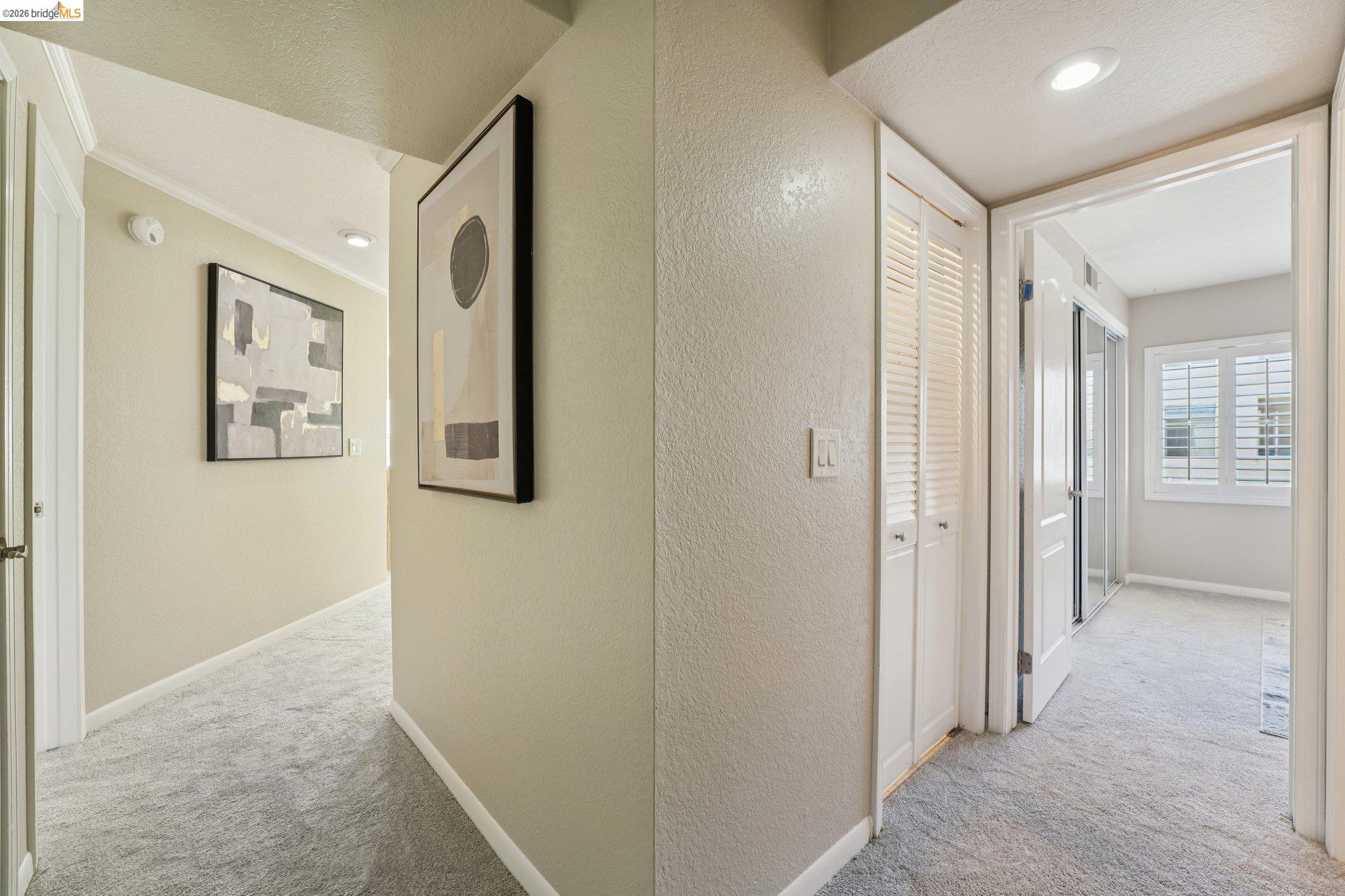 535 Pierce Street, Unit 3216 Albany, CA 94706 - Photo 28 of 47 Hall with light carpet and a textured wall