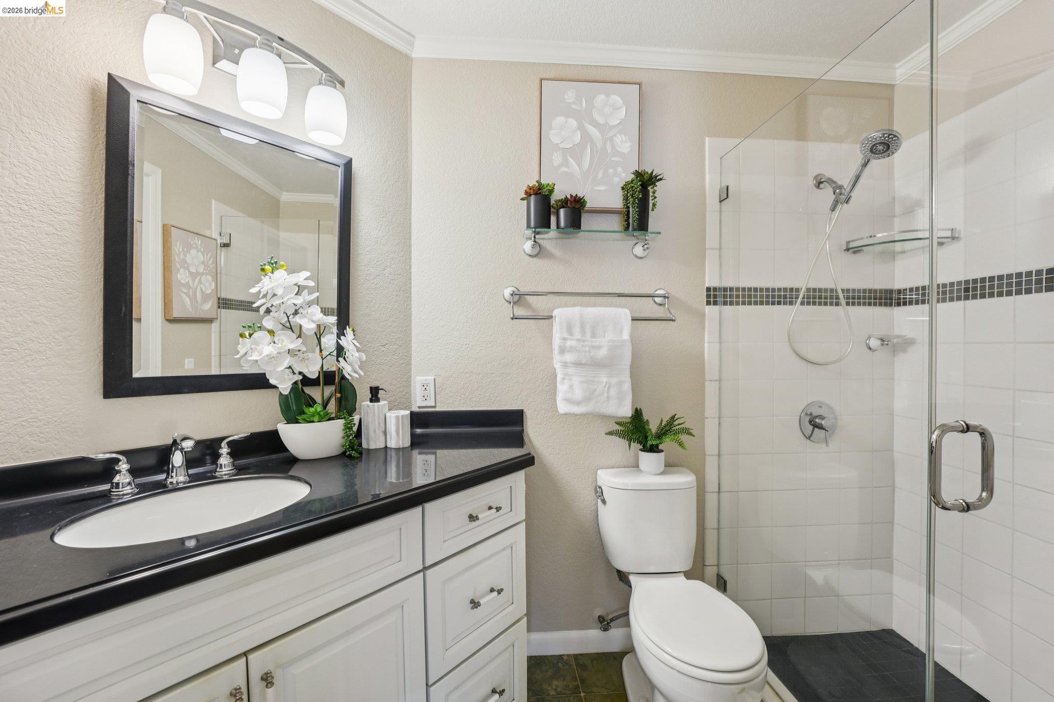 535 Pierce Street, Unit 3216 Albany, CA 94706 - Photo 34 of 47 Full bathroom with ornamental molding, a textured wall, a shower stall, and vanity