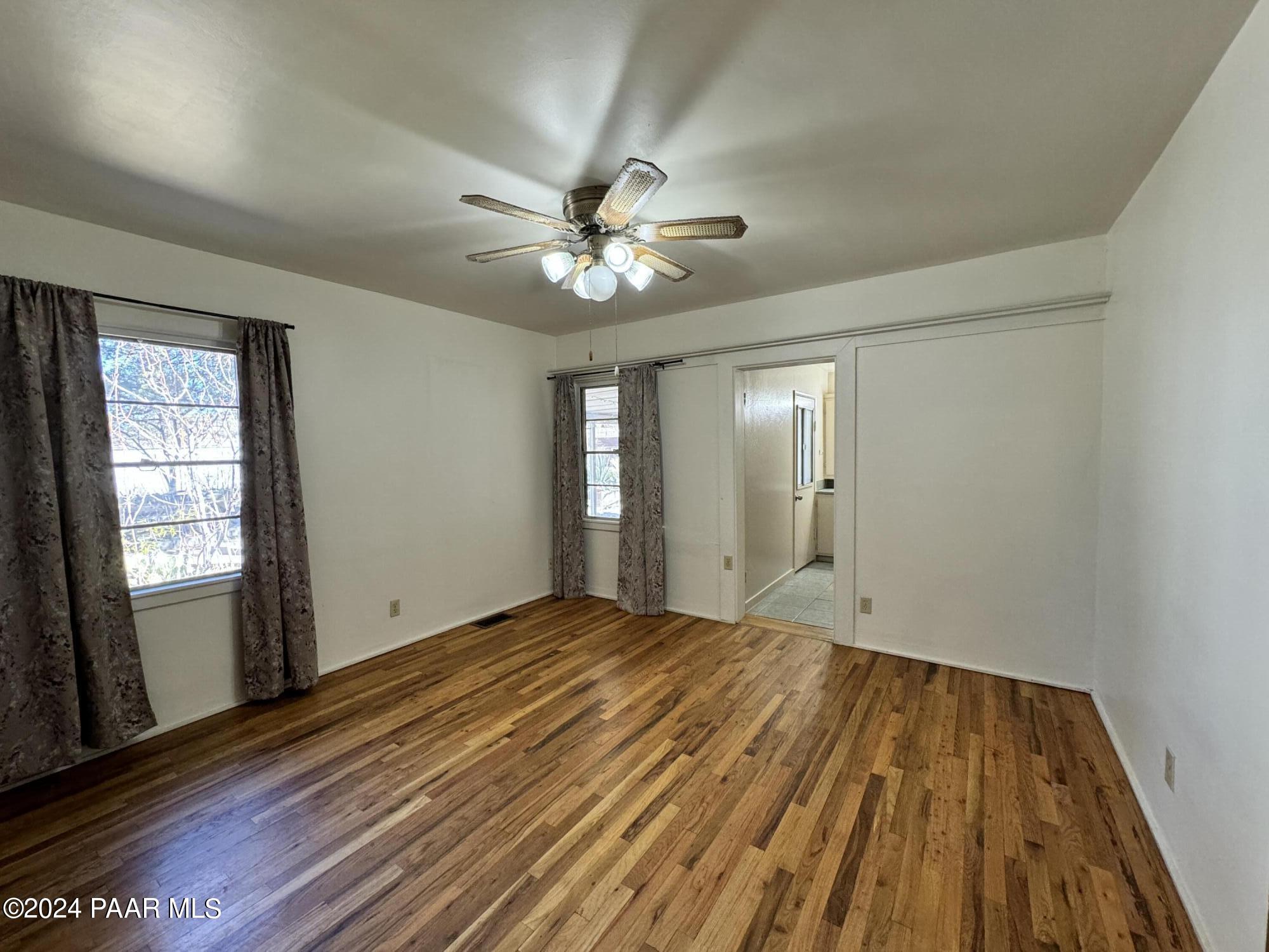 201 Robinson Drive Prescott, AZ 86303 - Photo 13 of 52 a view of an empty room with window and wooden floor