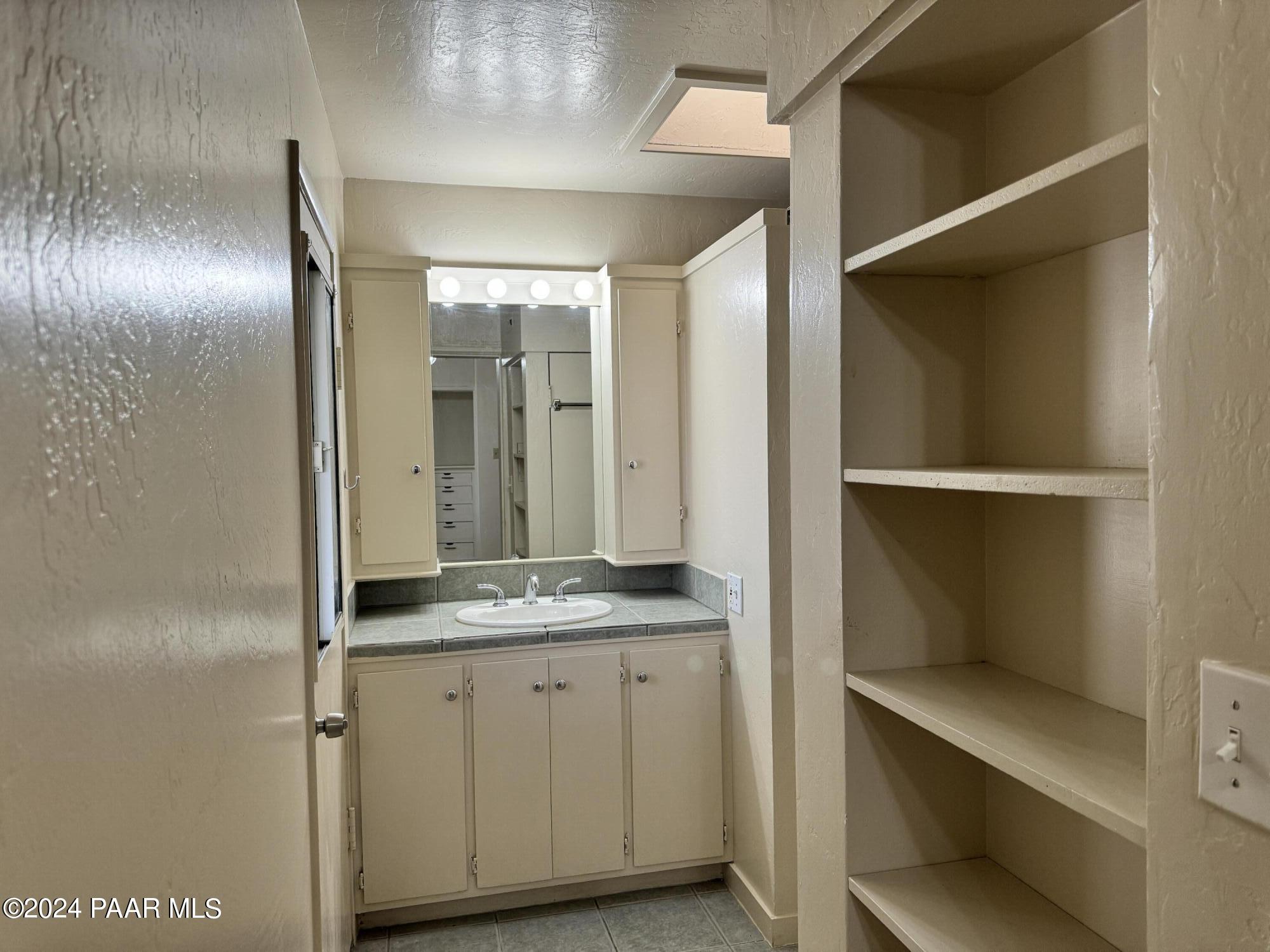 201 Robinson Drive Prescott, AZ 86303 - Photo 16 of 52 a bathroom with a granite countertop sink and a mirror