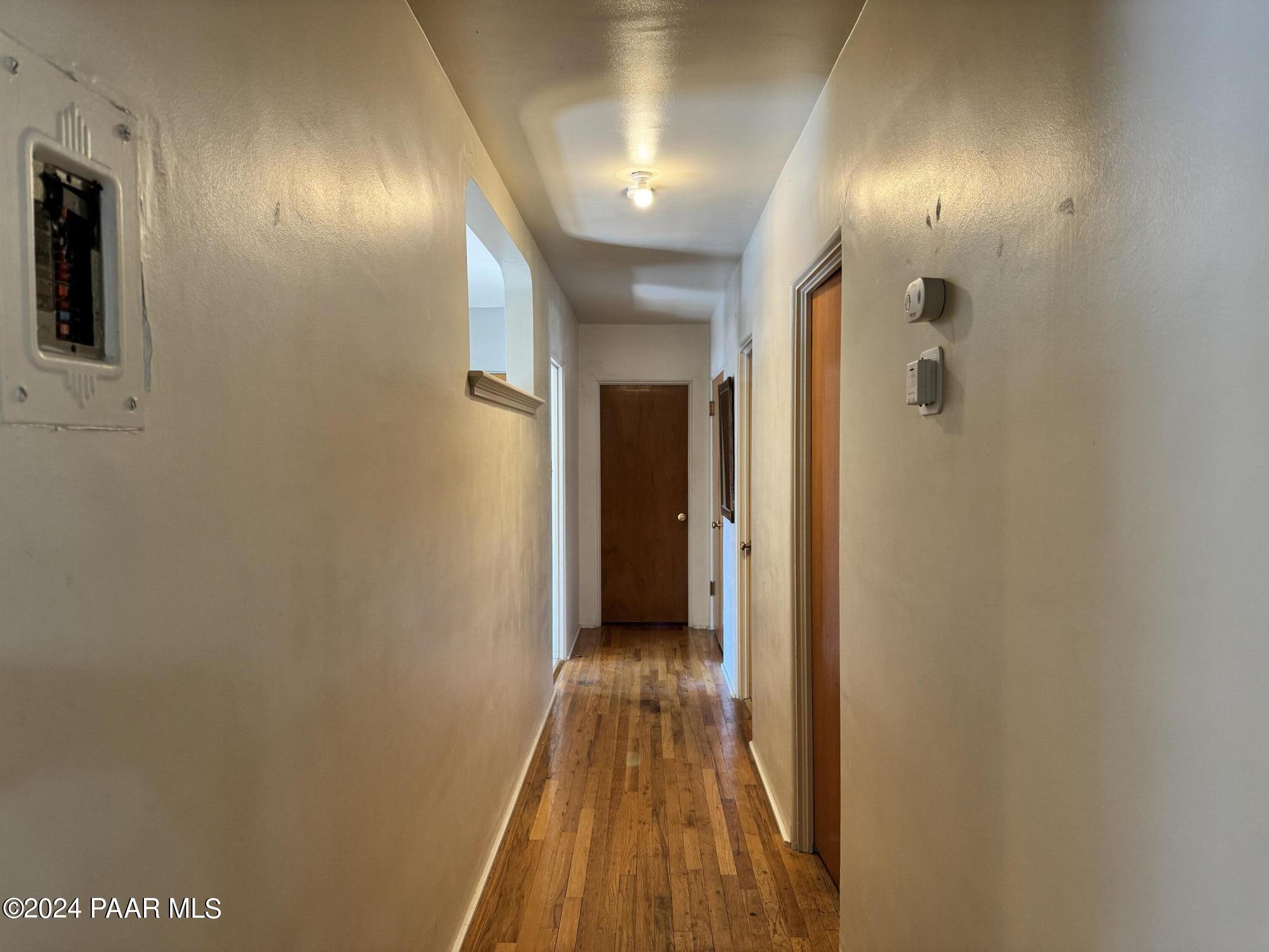 201 Robinson Drive Prescott, AZ 86303 - Photo 19 of 52 a view of a hallway with wooden floor and a bathroom