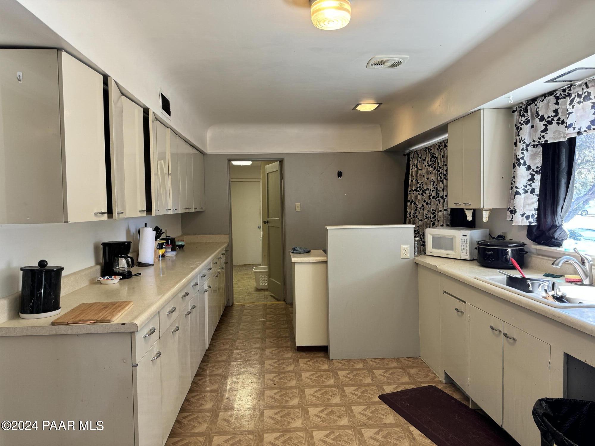 201 Robinson Drive Prescott, AZ 86303 - Photo 22 of 52 a kitchen with sink a refrigerator and cabinets