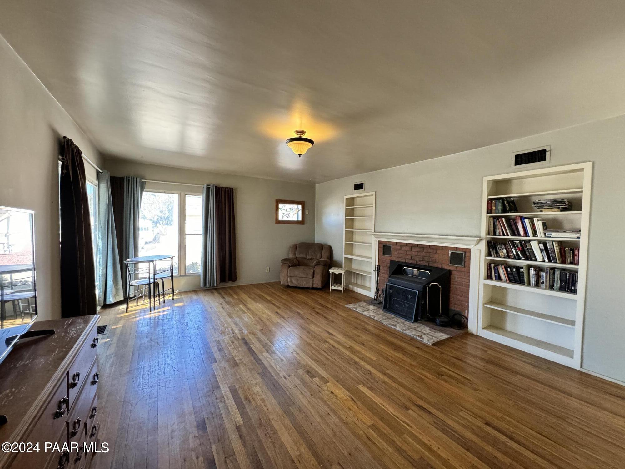 201 Robinson Drive Prescott, AZ 86303 - Photo 25 of 52 a view of an empty room with wooden floor and a window