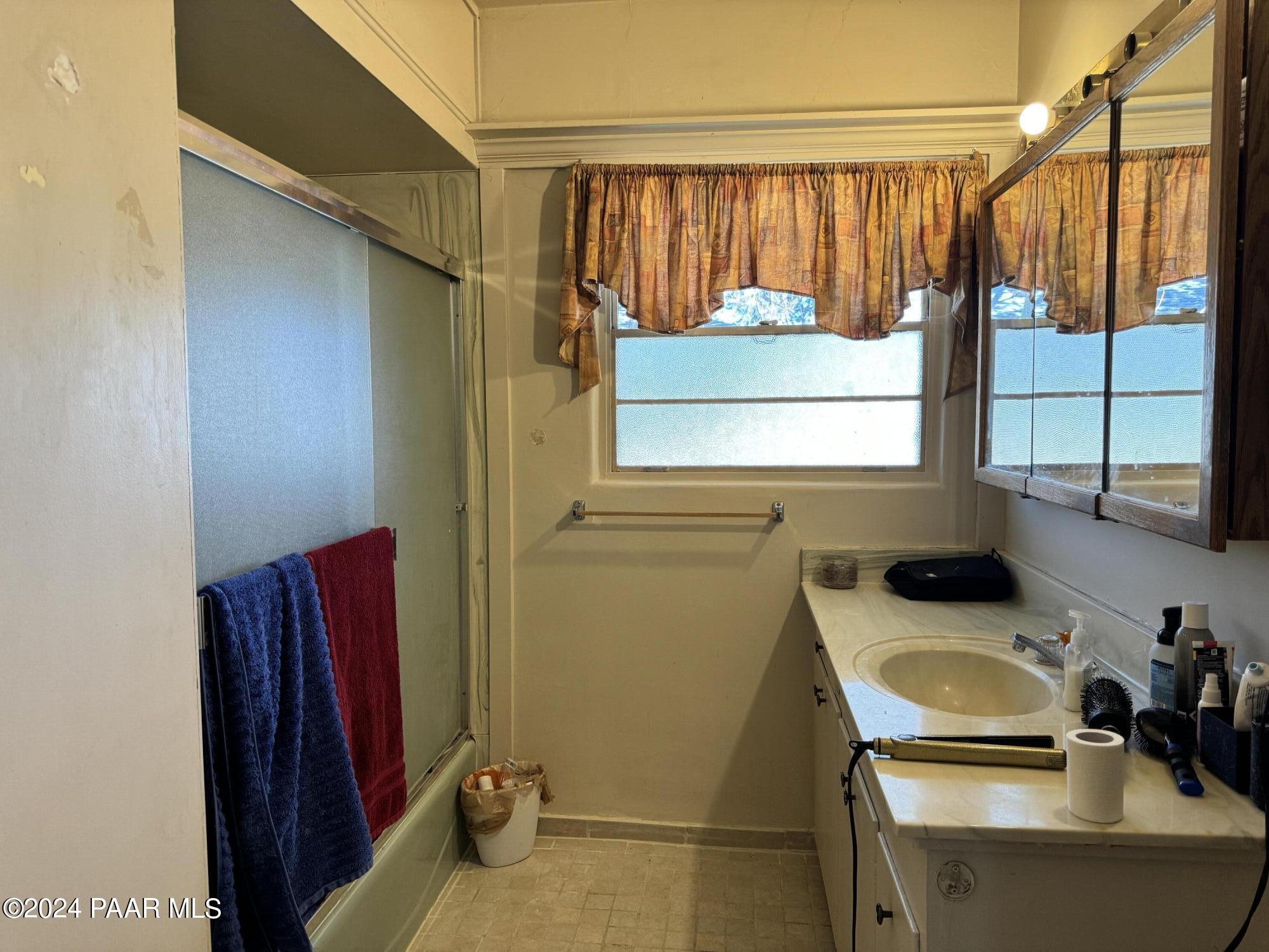 201 Robinson Drive Prescott, AZ 86303 - Photo 27 of 52 a bathroom with a sink a mirror and a shower