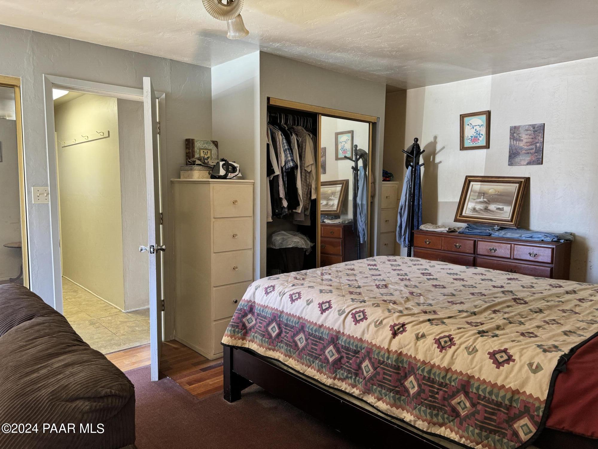 201 Robinson Drive Prescott, AZ 86303 - Photo 29 of 52 a bedroom with a bed and a dresser in it