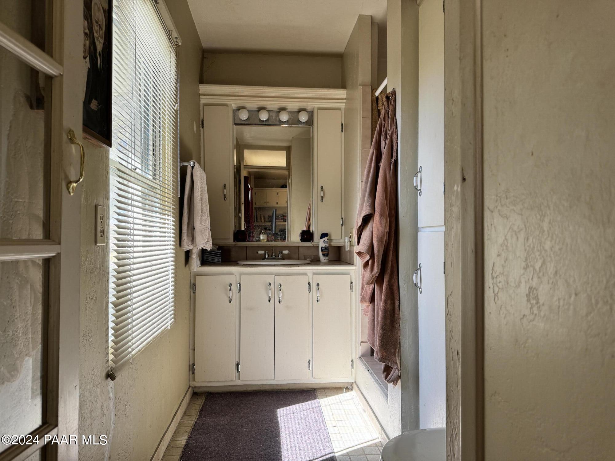 201 Robinson Drive Prescott, AZ 86303 - Photo 31 of 52 a bathroom with granite countertop a sink and a mirror