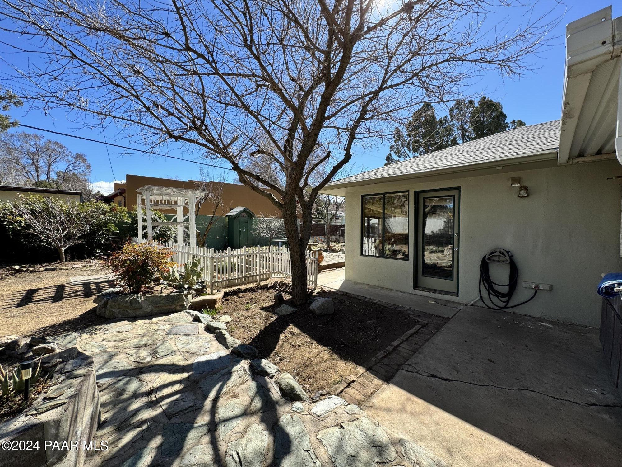 201 Robinson Drive Prescott, AZ 86303 - Photo 48 of 52 a view of a patio with table and chairs and wooden fence