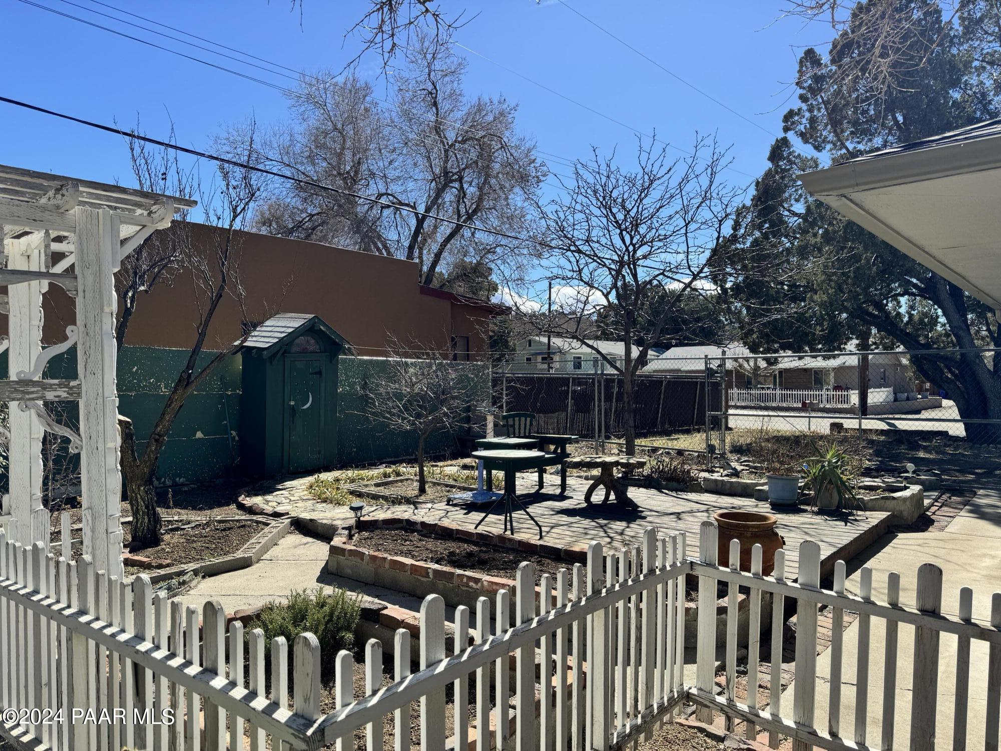 201 Robinson Drive Prescott, AZ 86303 - Photo 50 of 52 a view of a patio with table and chairs under an umbrella with a small yard