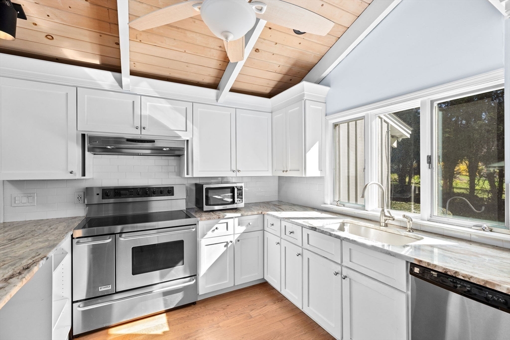 27 Everett Street Norfolk, MA 02056 - Photo 5 of 37 a kitchen with granite countertop white cabinets and white appliances