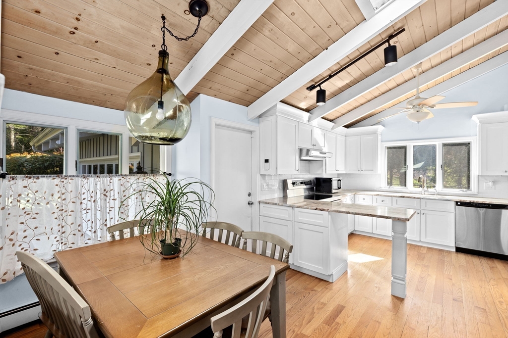 27 Everett Street Norfolk, MA 02056 - Photo 8 of 37 a kitchen with stainless steel appliances granite countertop a dining table chairs and granite counter tops