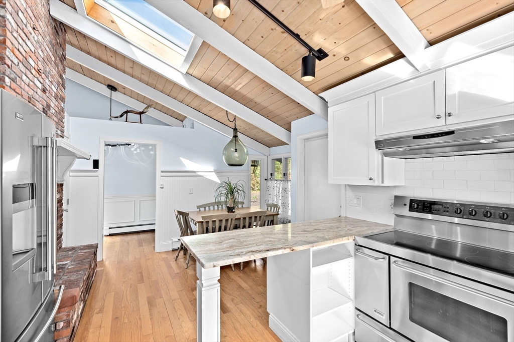 27 Everett Street Norfolk, MA 02056 - Photo 10 of 37 a kitchen with stainless steel appliances granite countertop a sink and cabinets
