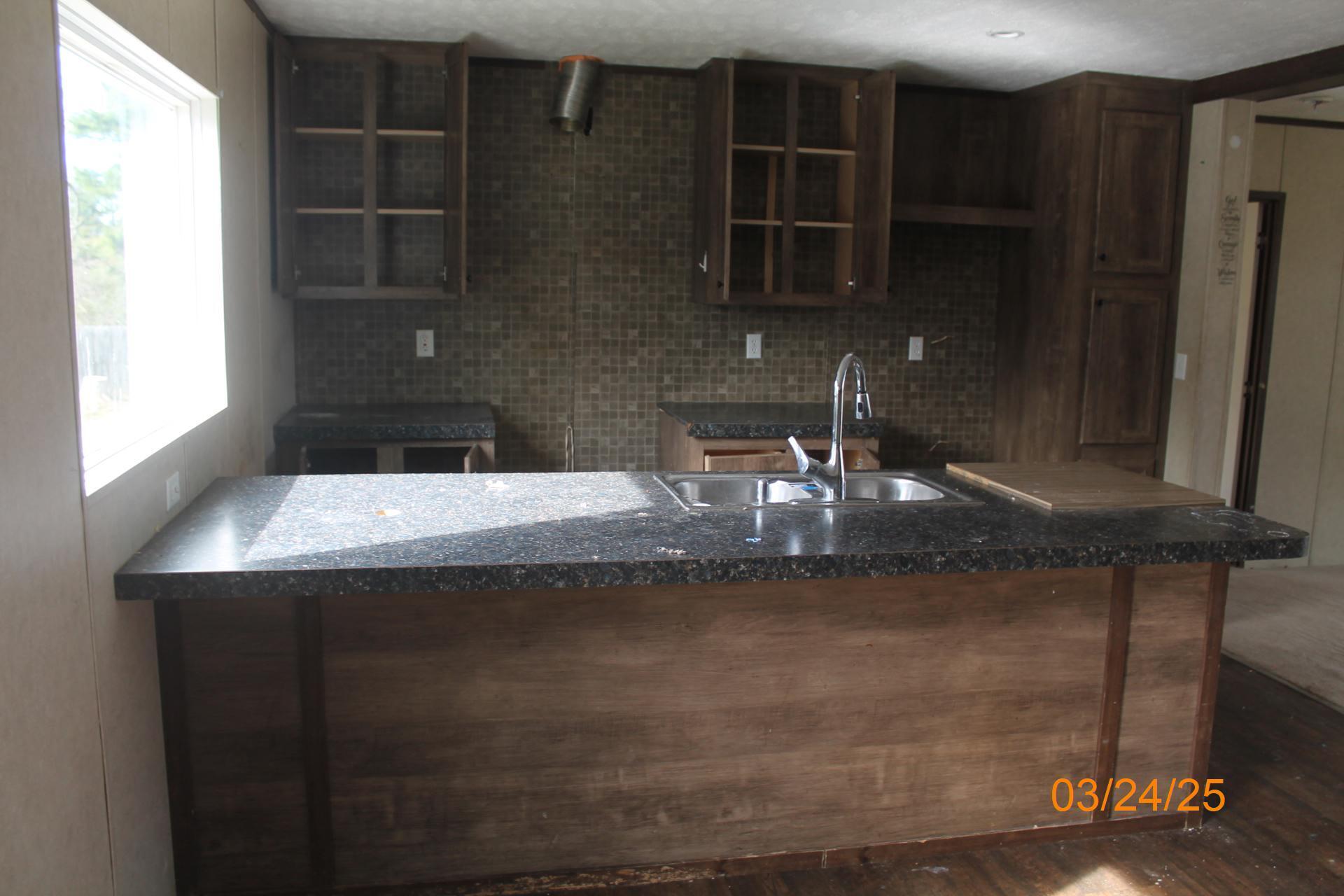 1935 Lick Ridge Road Northeast Check, VA 24072 - Photo 13 of 30 a kitchen with a sink and cabinets