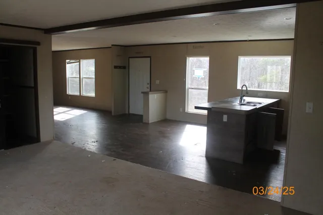 a view of an empty room with a fireplace