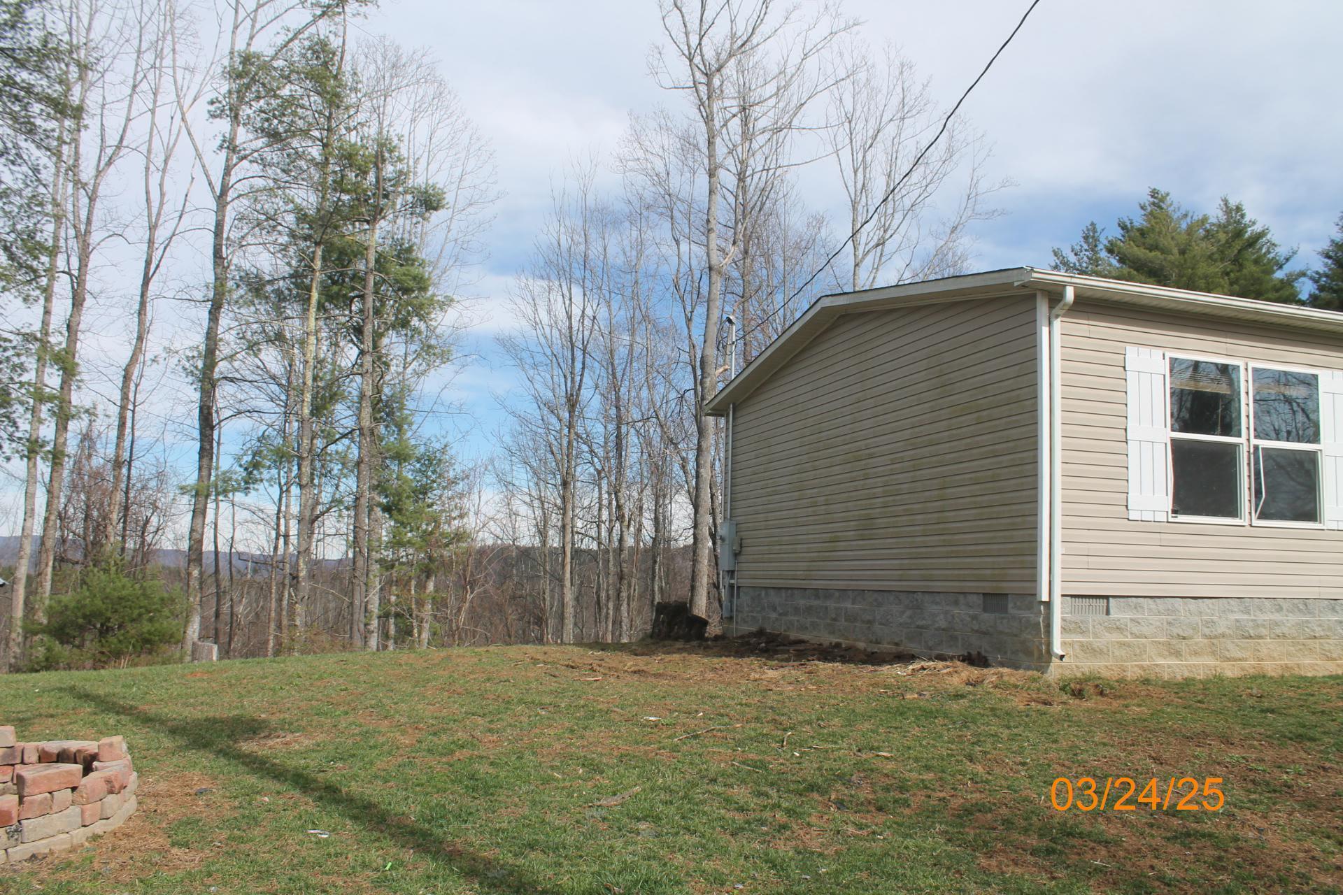 1935 Lick Ridge Road Northeast Check, VA 24072 - Photo 5 of 30 a backyard of a house with large trees