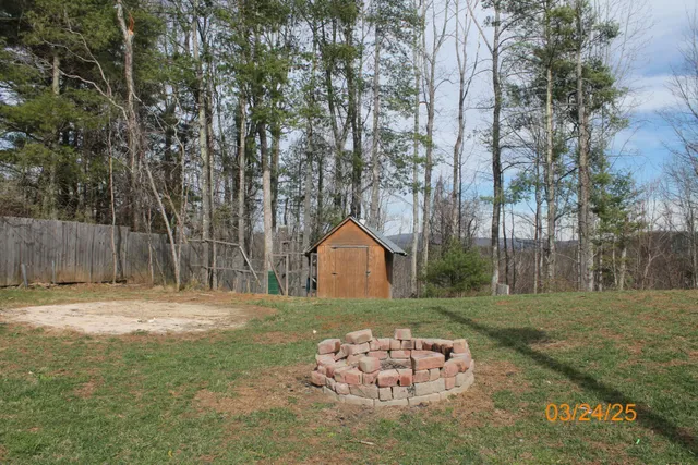 a view of outdoor space with wooden fence