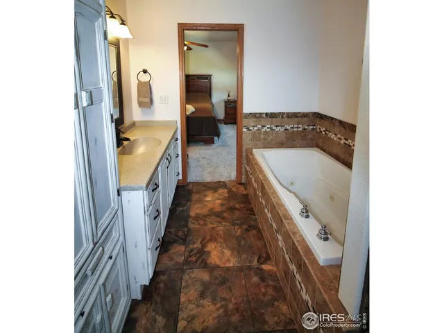 a bathroom with a sink a mirror and a bathtub