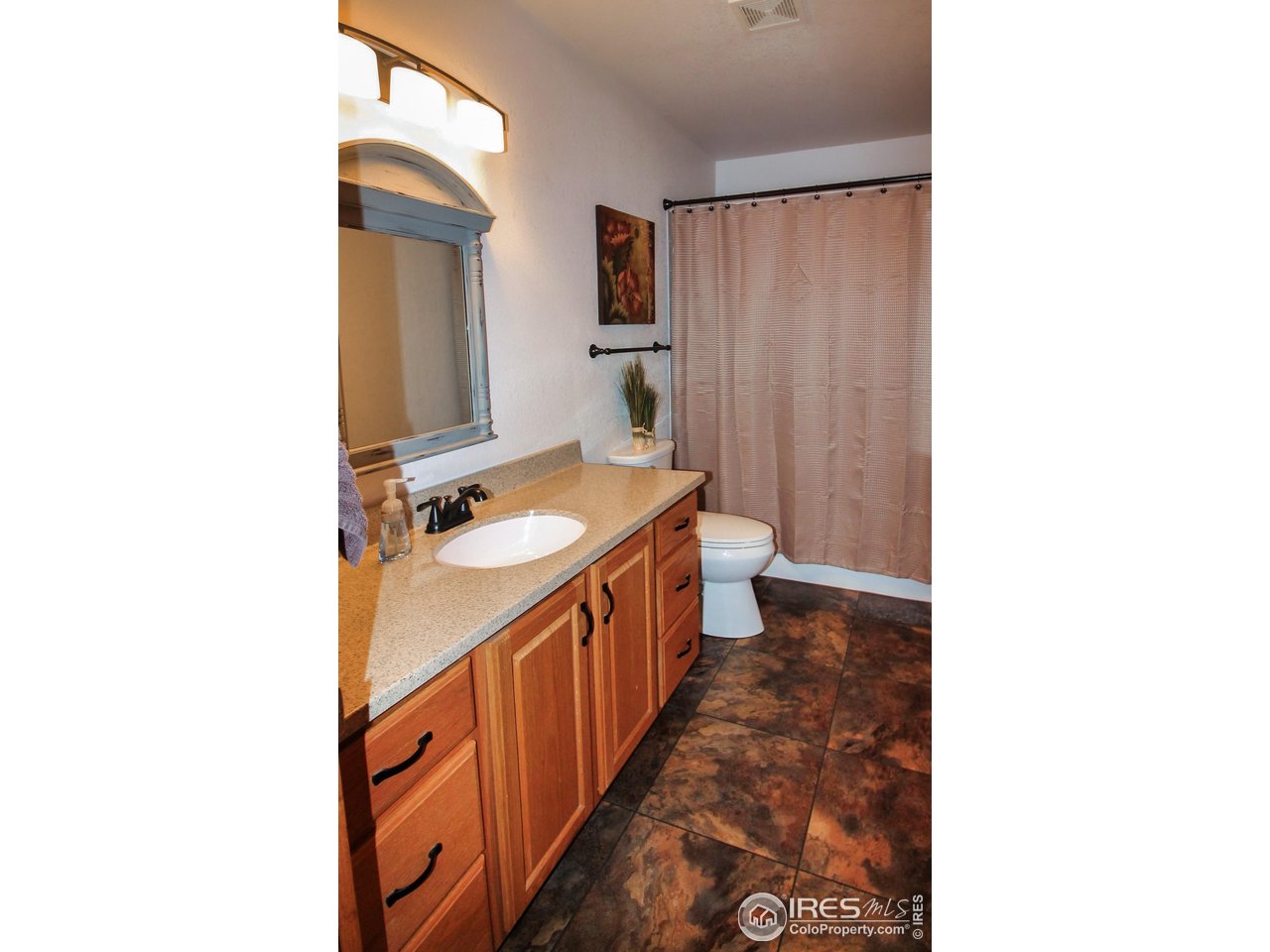 14363 Dakota Road Sterling, CO 80751 - Photo 16 of 40 a bathroom with a sink a mirror and a bathtub
