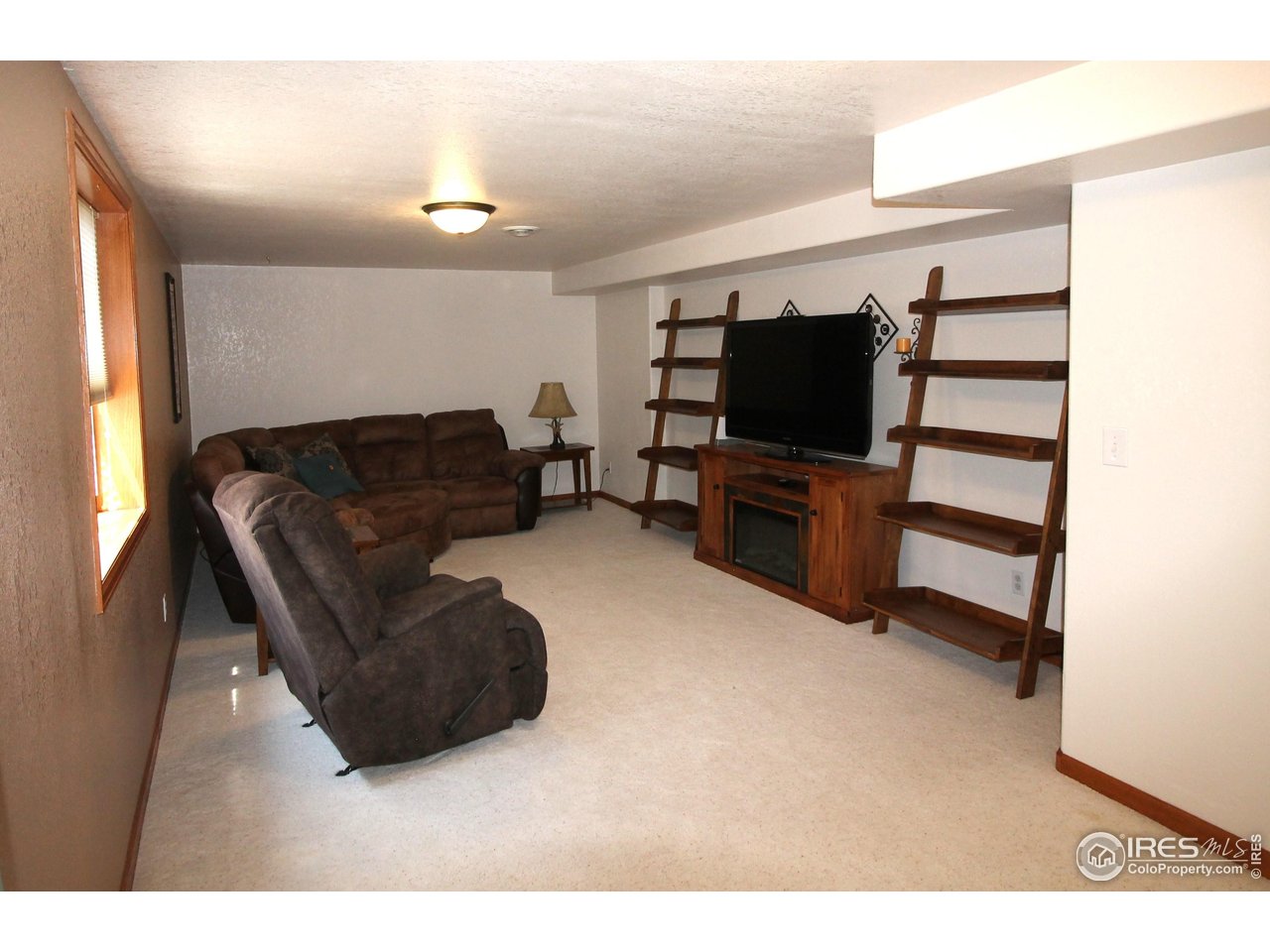 14363 Dakota Road Sterling, CO 80751 - Photo 22 of 40 a living room with furniture and a flat screen tv