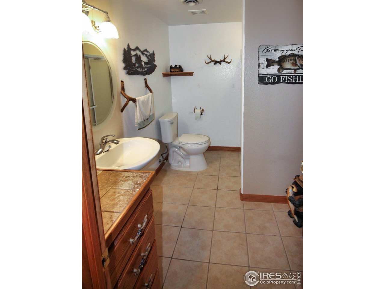 14363 Dakota Road Sterling, CO 80751 - Photo 23 of 40 a bathroom with a toilet and a mirror