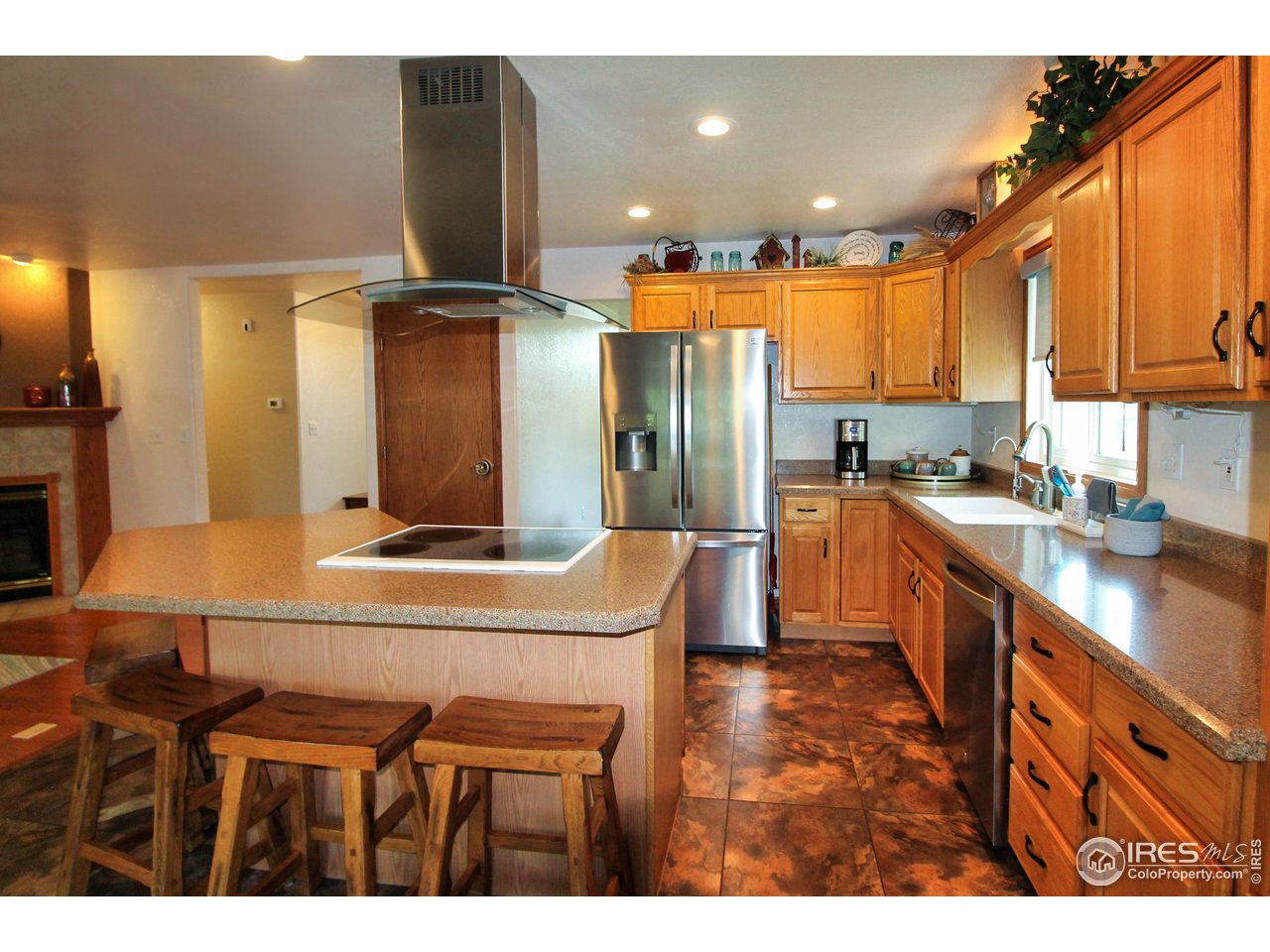 14363 Dakota Road Sterling, CO 80751 - Photo 7 of 40 a kitchen with kitchen island granite countertop a sink cabinets and stainless steel appliances