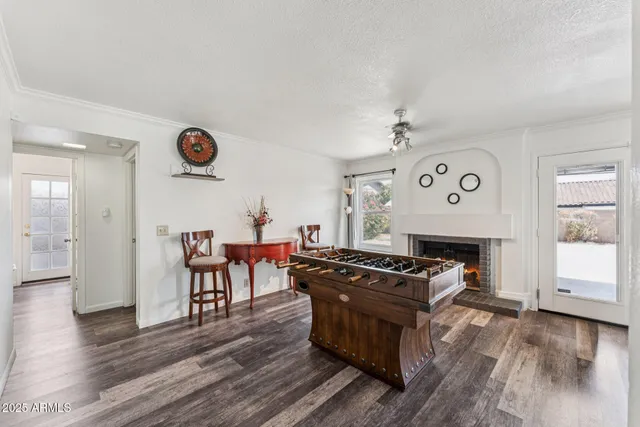a living room with furniture a wooden floor and a fireplace
