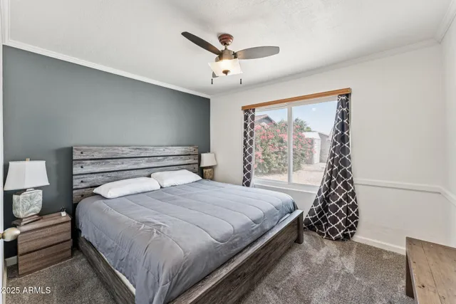 a bedroom with a large bed and a chandelier