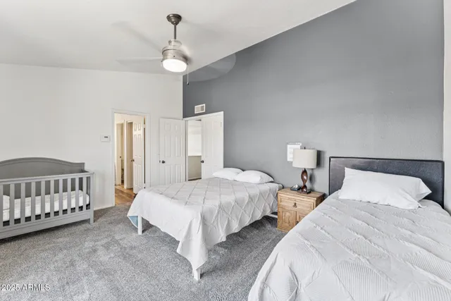 a bedroom with two beds and chandelier