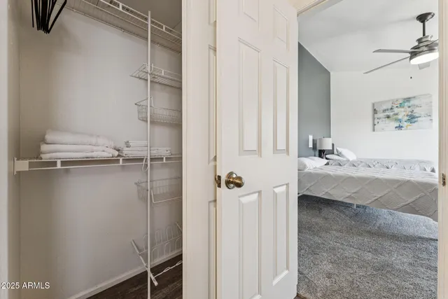 a bathroom with a granite countertop sink a toilet and a shower