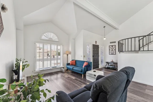 a living room with furniture and a large window